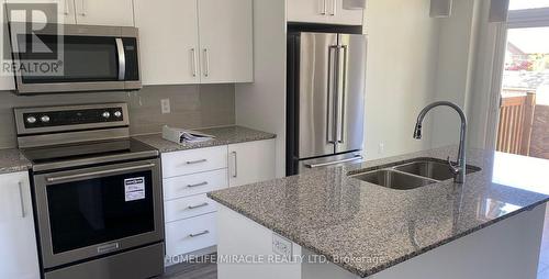 02 - 16 Paradise Grove, Niagara-On-The-Lake, ON - Indoor Photo Showing Kitchen With Stainless Steel Kitchen With Double Sink With Upgraded Kitchen