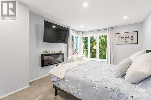 280 Mcclellan Road Unit#58, Ottawa, ON - Indoor Photo Showing Bedroom With Fireplace