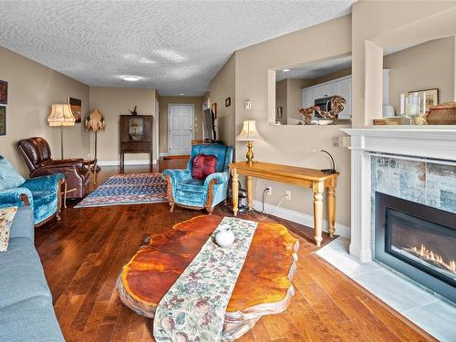 210-2550 Bevan Ave, Sidney, BC - Indoor Photo Showing Living Room With Fireplace