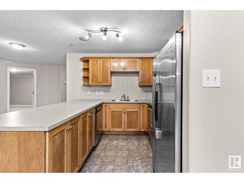 #230 1520 Hammond Gate Ga Nw, Edmonton, AB - Indoor Photo Showing Kitchen With Double Sink