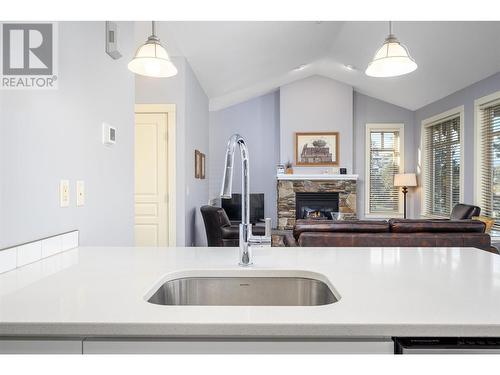 251 Predator Ridge Drive Unit# 18, Vernon, BC - Indoor Photo Showing Kitchen With Fireplace