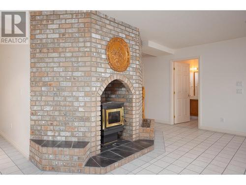 9611 Kilkenny Place, Fintry, BC - Indoor Photo Showing Other Room With Fireplace