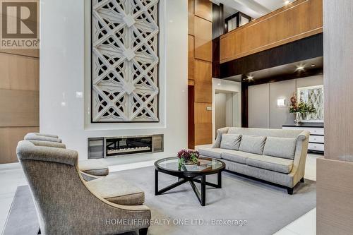 201 - 100 Harrison Gardens Boulevard, Toronto, ON - Indoor Photo Showing Living Room With Fireplace