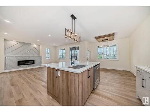 8387 Shaske Cr Nw, Edmonton, AB - Indoor Photo Showing Kitchen With Fireplace