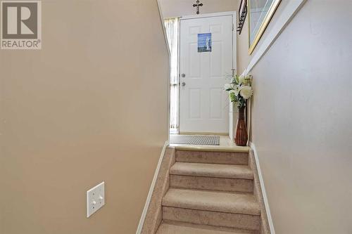 Stairs going up to front entry - 319 16 Street E, Brooks, AB - Indoor Photo Showing Other Room