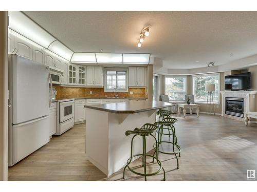 #312 9008 99 Av Nw, Edmonton, AB - Indoor Photo Showing Kitchen With Fireplace With Double Sink