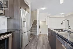 Kitchen showcases quartz counters, white subway tile backsplash, breakfast bar + an abundance of natural light. - 