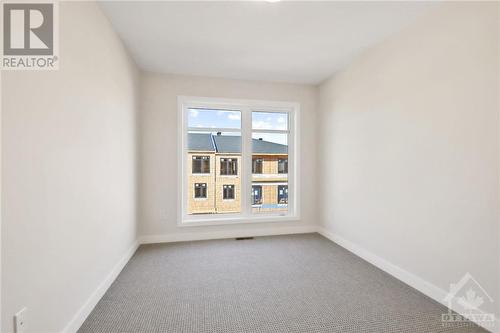 A generously sized secondary bedroom OVERSZIZED WINDOWS - 402 Jewelwing Private, Ottawa, ON - Indoor Photo Showing Other Room