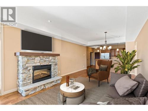 This photo is virtually staged - 2760 Auburn Road Unit# 102, West Kelowna, BC - Indoor Photo Showing Living Room With Fireplace