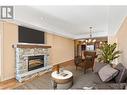 This photo is virtually staged - 2760 Auburn Road Unit# 102, West Kelowna, BC  - Indoor Photo Showing Living Room With Fireplace 