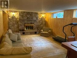 You enter a bright, spacious rec room with fireplace. - 