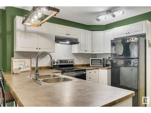 #120 5001 62 Street Nw, Beaumont, AB - Indoor Photo Showing Kitchen With Double Sink