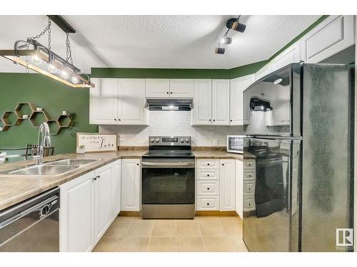 #120 5001 62 Street Nw, Beaumont, AB - Indoor Photo Showing Kitchen With Double Sink