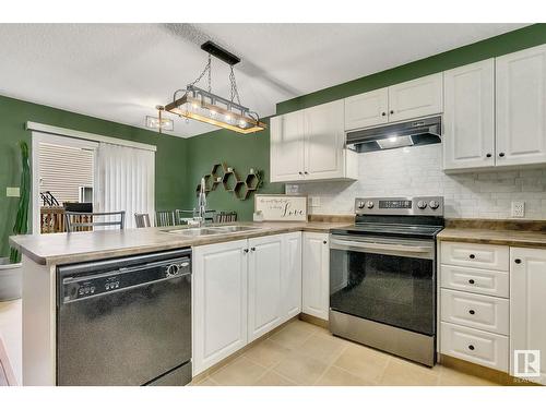 #120 5001 62 Street Nw, Beaumont, AB - Indoor Photo Showing Kitchen With Double Sink