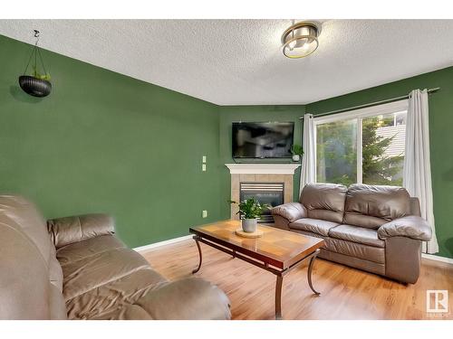 #120 5001 62 Street Nw, Beaumont, AB - Indoor Photo Showing Living Room With Fireplace