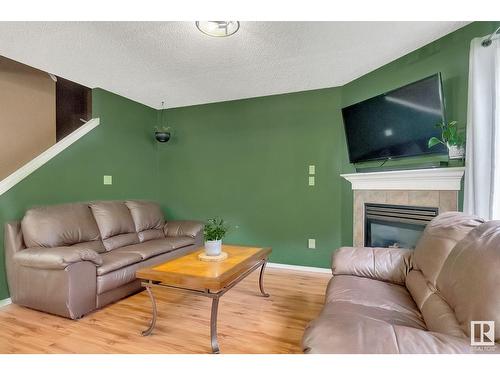 #120 5001 62 Street Nw, Beaumont, AB - Indoor Photo Showing Living Room With Fireplace