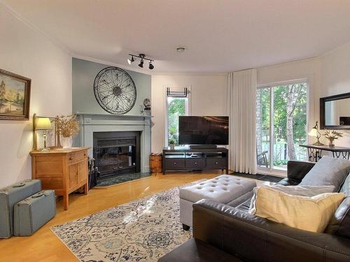 Living room - 104-787 Ch. Ozias-Leduc, Otterburn Park, QC - Indoor Photo Showing Living Room With Fireplace