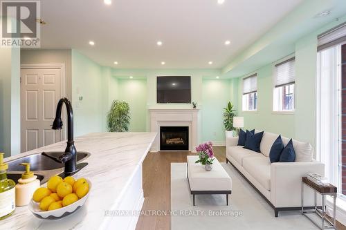 B202 - 98 Cornell Park Avenue, Markham, ON - Indoor Photo Showing Living Room With Fireplace