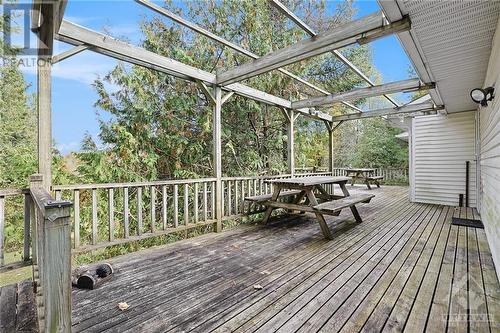 Back deck leads to rear side entry into garage and into side entry to kitchen - 4000 Stonecrest Road, Ottawa, ON - Outdoor With Deck Patio Veranda With Exterior