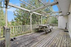 Back deck leads to rear side entry into garage and into side entry to kitchen - 