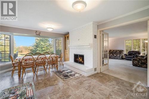 Kitchen with window with a view! - 4000 Stonecrest Road, Ottawa, ON - Indoor Photo Showing Living Room With Fireplace