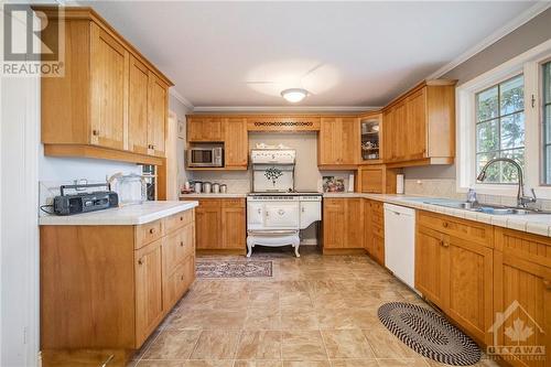 Bright open kitchen with beautiful cookstove - 4000 Stonecrest Road, Ottawa, ON - Indoor Photo Showing Kitchen With Double Sink