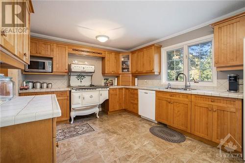 Bright open kitchen with beautiful cookstove - 4000 Stonecrest Road, Ottawa, ON - Indoor Photo Showing Kitchen With Double Sink