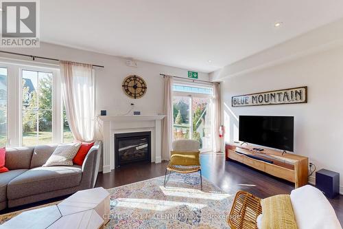 31 - 171 Snowbridge Way, Blue Mountains, ON - Indoor Photo Showing Living Room With Fireplace