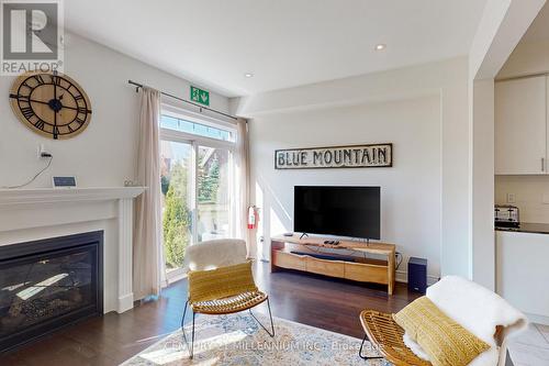 31 - 171 Snowbridge Way, Blue Mountains, ON - Indoor Photo Showing Living Room With Fireplace