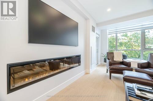 209 - 80 Port Street E, Mississauga, ON - Indoor Photo Showing Living Room With Fireplace