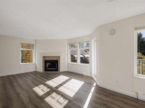 301C-4678 Elk Lake Dr, Saanich, BC - Indoor Photo Showing Living Room With Fireplace