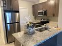 709 - 5917 Main Street, Whitchurch-Stouffville, ON  - Indoor Photo Showing Kitchen With Stainless Steel Kitchen With Double Sink With Upgraded Kitchen 