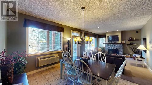 300 Bighorn Boulevard Unit# 324, Radium Hot Springs, BC - Indoor Photo Showing Dining Room With Fireplace