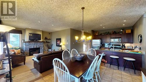 300 Bighorn Boulevard Unit# 324, Radium Hot Springs, BC - Indoor Photo Showing Dining Room With Fireplace