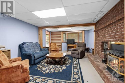 lower level rec room - 196 Indian Hill Road, Pakenham, ON - Indoor With Fireplace