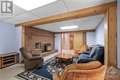 lower level rec room - 196 Indian Hill Road, Pakenham, ON - Indoor Photo Showing Basement With Fireplace