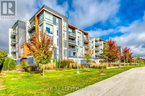 208 - 3028 Creekshore Common S, Oakville, ON - Outdoor With Balcony With Facade