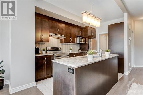 Open Concept Living, Dining, Kitchen with Nat Gas Fireplace - 816 Loosestrife Way, Ottawa, ON - Indoor Photo Showing Kitchen