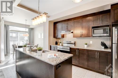 Open Concept Living, Dining, Kitchen with Nat Gas Fireplace - 816 Loosestrife Way, Ottawa, ON - Indoor Photo Showing Kitchen With Upgraded Kitchen