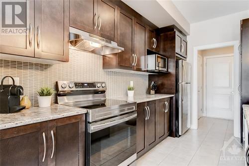 Open Concept Living, Dining, Kitchen with Nat Gas Fireplace - 816 Loosestrife Way, Ottawa, ON - Indoor Photo Showing Kitchen With Upgraded Kitchen