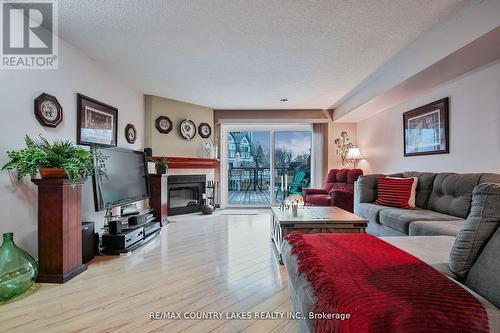 9 - 24 Laguna Parkway, Ramara, ON - Indoor Photo Showing Living Room With Fireplace