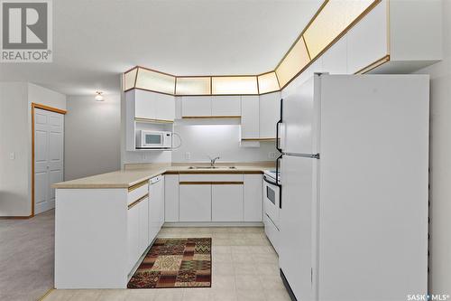 101 214 Ross Avenue, Dalmeny, SK - Indoor Photo Showing Kitchen With Double Sink