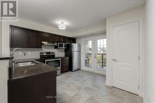 307 - 1440 Main Street E, Milton, ON - Indoor Photo Showing Kitchen With Stainless Steel Kitchen With Double Sink With Upgraded Kitchen