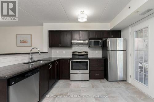 307 - 1440 Main Street E, Milton, ON - Indoor Photo Showing Kitchen With Stainless Steel Kitchen With Double Sink