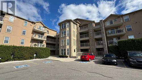 210 - 1460 Bishops Gate, Oakville, ON - Outdoor With Balcony With Facade