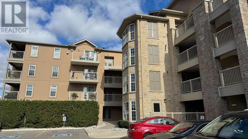 210 - 1460 Bishops Gate, Oakville, ON - Outdoor With Balcony With Facade