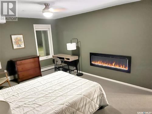 201 395 River Street E, Prince Albert, SK - Indoor Photo Showing Bedroom With Fireplace