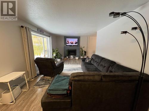 7608 Old Alaska Highway, Fort Nelson, BC - Indoor Photo Showing Living Room With Fireplace