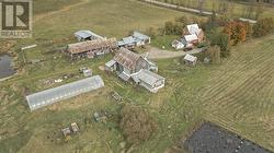 aerial view of farm and oversized greenhouse - 