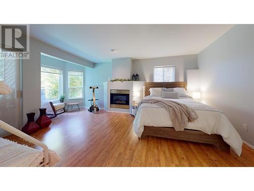 2915 Canada Way, Blind Bay, BC - Indoor Photo Showing Bedroom With Fireplace